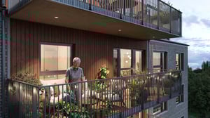 Modernt flerfamiljshus med trä- och tegelväggar, samt rymliga balkonger dekorerade med växter och utomhusbelysning