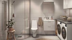 Badrum med duschhörna och tvättmaskin och torktumlare