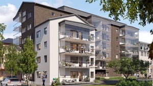 Flerfamiljshus med balkonger och glaspartier, omgivna av grönska och parkerade bilar