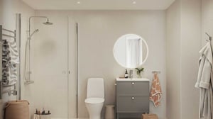 3:a med betonggrått badrum med duschhörna