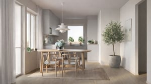 Lägenhet med ljus matplats och kök, inredd med träbord, stolar och växter