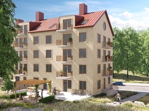 Flerbostadshus med balkonger, pergola och grönskande omgivning