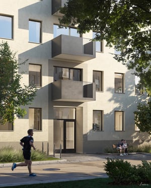 Flerbostadshus med balkonger och gröna trädgårdsmiljöer, med en löpare i förgrunden och två personer sittande på en bänk