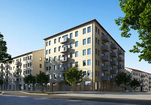 Flerfamiljshus med balkonger och träd framför