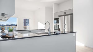 Inflyttningsklar lägenhet med modern köksö, rostfria vitvaror och ljusa ytor