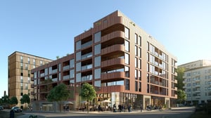 Nyproducerade flerbostadshus med butiker i bottenvåningen och stora glaspartier