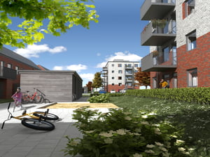 Moderna bostadshus med röda och grå fasader, omgivna av grönska. Personer och cyklar syns nära byggnaderna under en klarblå himmel