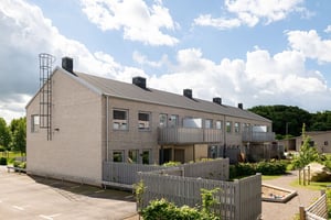 Flerbostadshus i radhuskänsla med gemensam gård och lekpark mellan husen