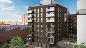 Modern bostadshus med balkonger och innergård i ett stadsmiljöområde