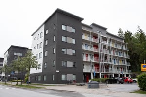 Hyresrättsfastighet med loftgångar och parkering med bilar