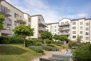 Innergård till hyresfastighet, med grönska, lekytor och sittplatser