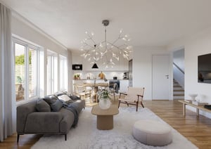 Vardagsrum med öppen planlösning mot kök, ljusa ytskikt, stora fönster och modern inredning
