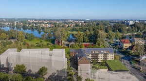 Illustration av planerat bostadsprojekt i Karlstad med flerbostadshus intill grönområde och vattendrag