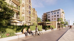 Bostadsområde med moderna flerbostadshus, grönska, cyklar och människor längs en lugn gångväg