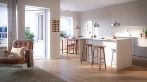 Lägenhet med öppen planlösning, kök med köksö och ljus vardagsrumsdel