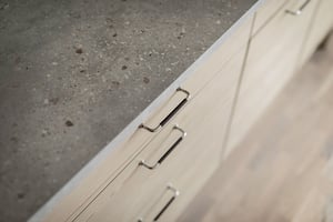 inflyttningsklar lägenhet med grå betonggolv och ljusa köksluckor