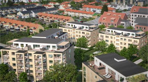 Lägenhetsbyggnader med moderna fasader, terrasser och grönska, omgivna av villor och mindre byggnader i ett bostadsområde