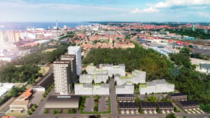 Flygvy över ett bostadsområde med flerbostadshus, grönområden och Helsingborg i bakgrunden