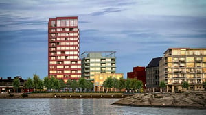 Bostadshus vid havet, i Karlskrona, med moderna lägenheter och grönska på kajen