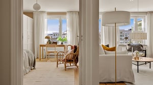 Lägenhet med ljus interiör, sovrum och vardagsrum med stora fönster