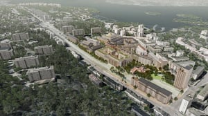 Flygvy över Örnsberg med flerfamiljshus, grönytor och väg nära vatten