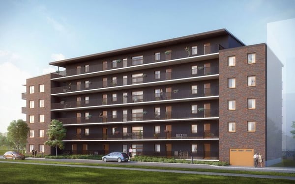 Flerfamiljshus med balkonger och fasad i tegel