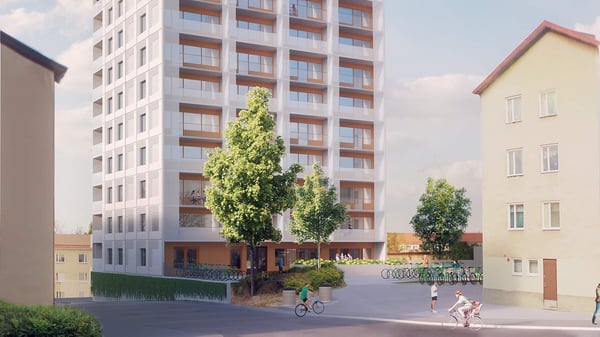 Flerbostadshus, träd och cyklister