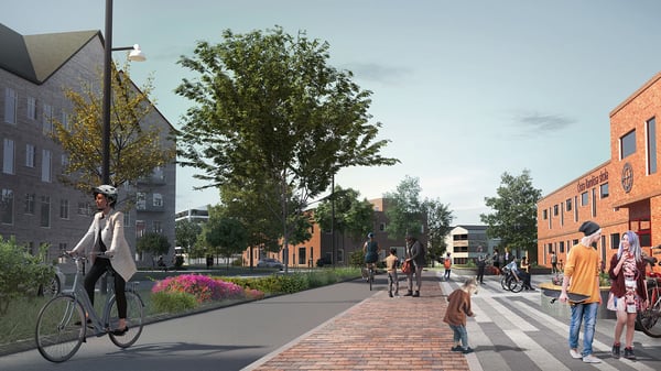 Person på cykel Östra Ramlösa med bostadshus, träd och människor på trottoaren