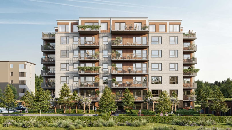 Flerbostadshus med modern arkitektur, flera balkonger och grönskande utomhusmiljö