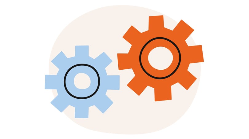Två kugghjul, ett blått och ett orange, placerade mot en ljus bakgrund