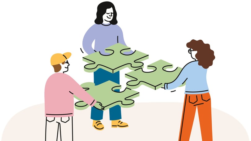 Människor som lägger ett stort pussel