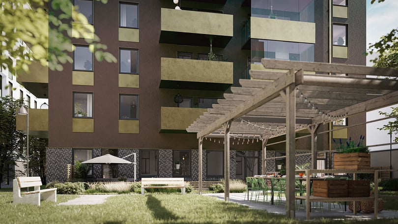 Grön innergård, pergola, sittplatser och flerfamiljshus