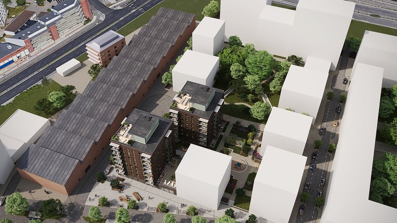 Flygvy över bostadsområde med flerbostadshus, gröna innergårdar och omgivande kvarter