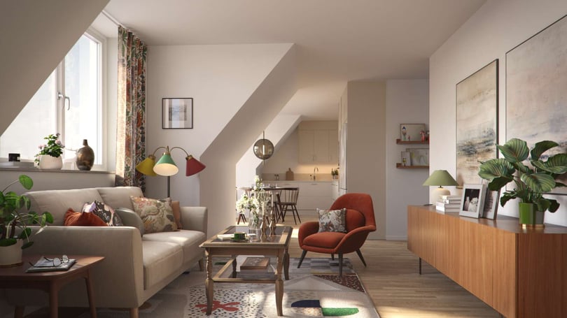 Vardagsrum med soffa, fåtölj, soffbord och inredningsdetaljer, öppet mot kök