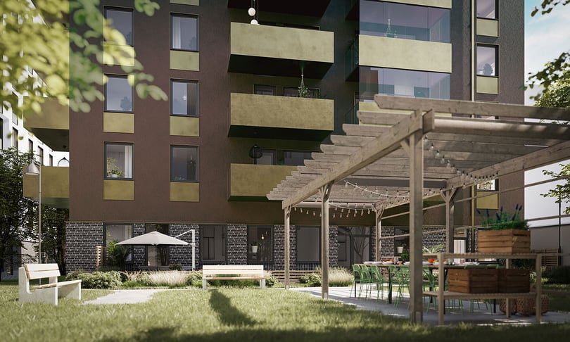 Innergård med flerbostadshus, sittplatser, pergola och grönskande trädgård
