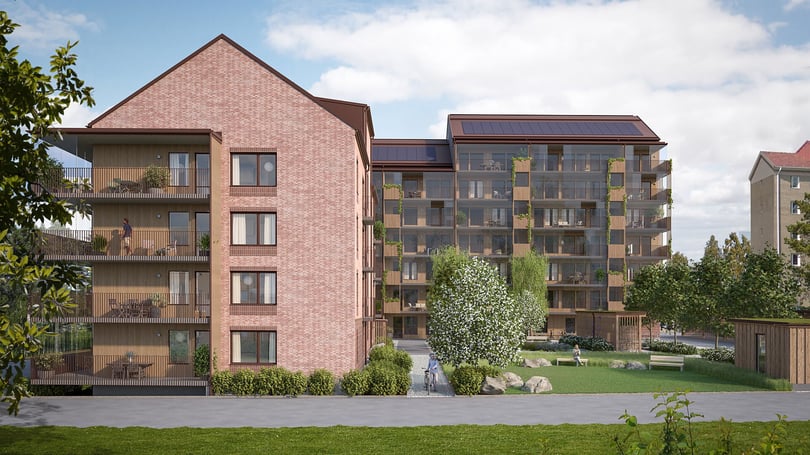 Visualisering av bostadshus med balkonger, grönytor och solpaneler på taket
