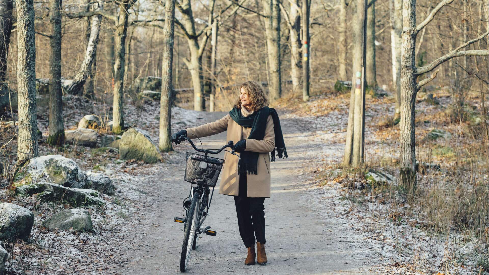 Kvinna i skogen med cykel