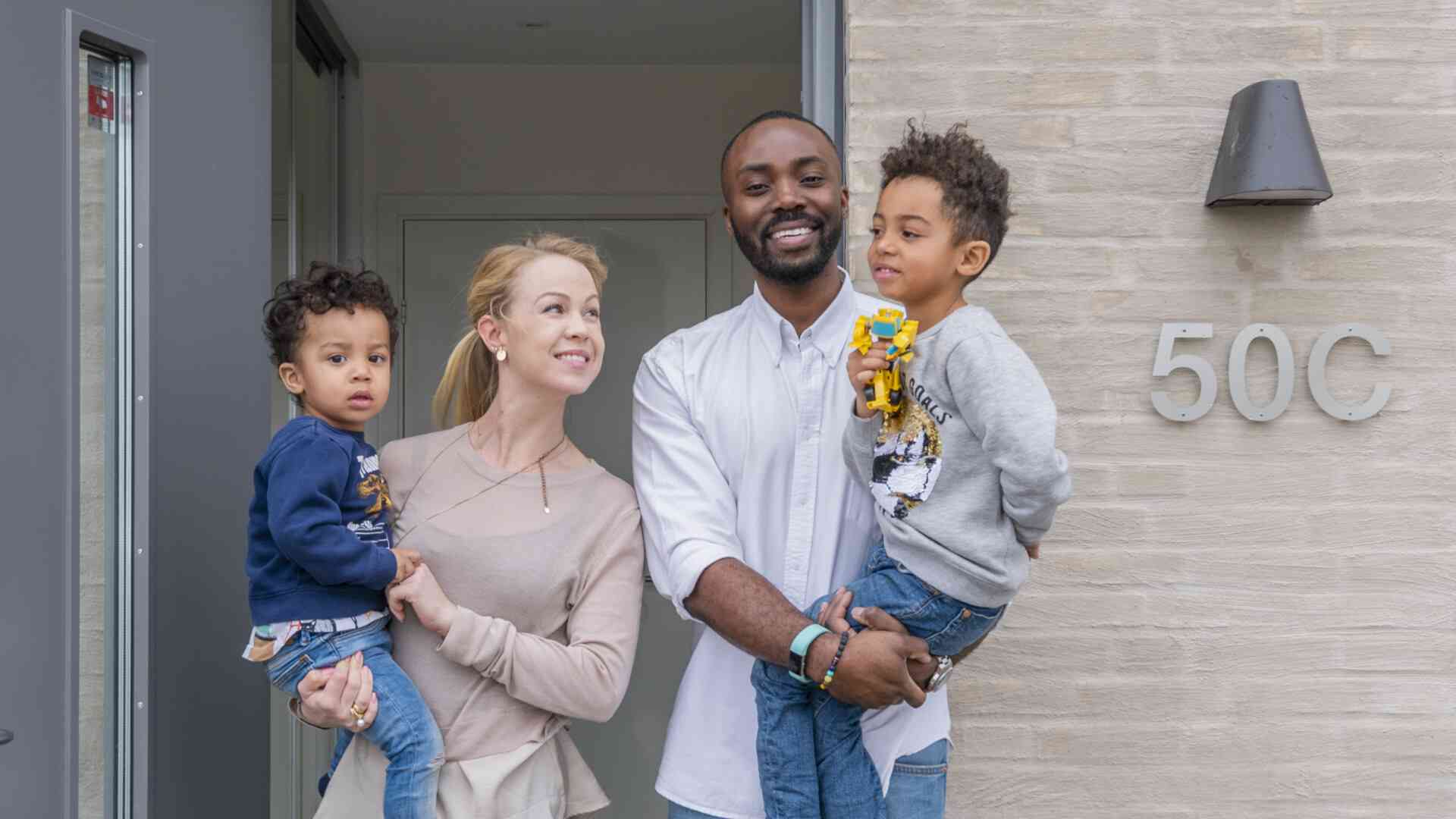 Familj med två barn i dörröppning